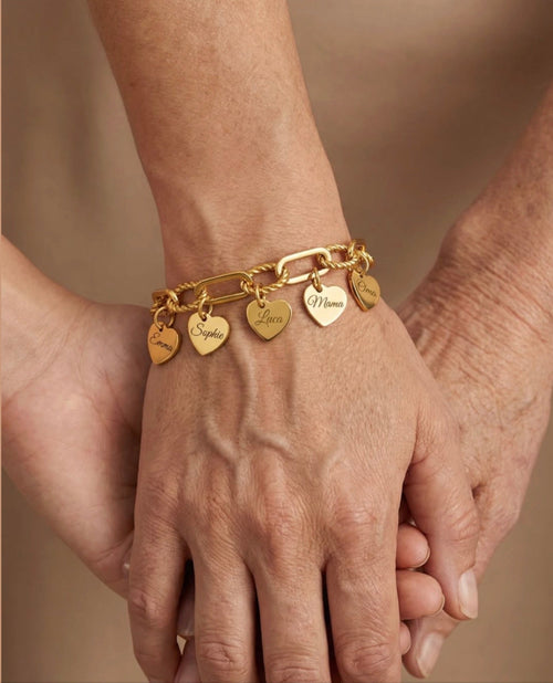 The Florence charm bracelet worn — hearts with engraved names